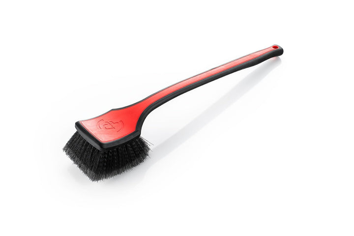 Detail Factory brush front view showing ergonomic red handle and head for improved control