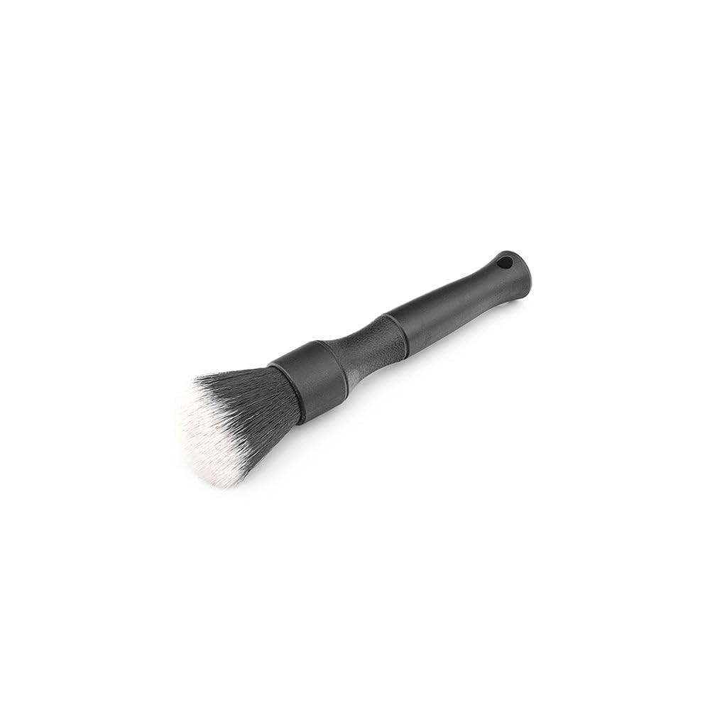 Detail Factory brushes cleaning car vent and emblem demonstrating safe precise reach