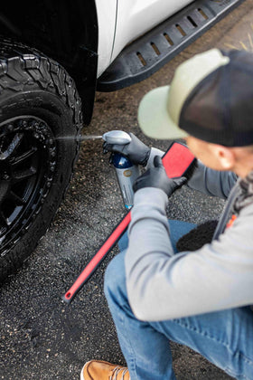 Detail Factory brush in use inside wheel well removing mud and road grime