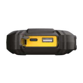 DeWalt jump starter in use on a roadside helping a vehicle restart at night