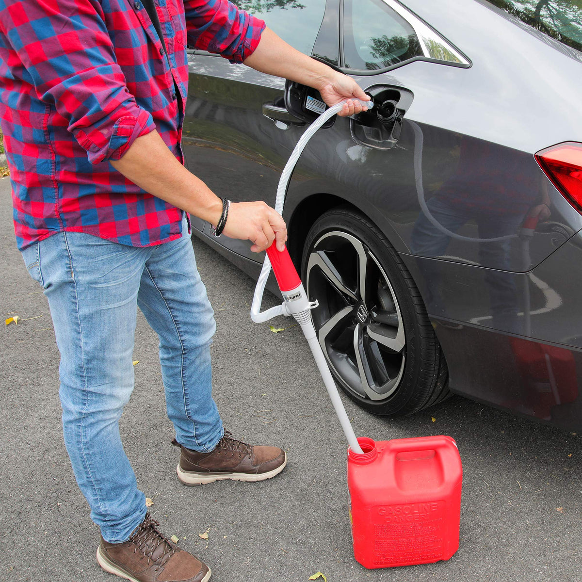 DEWAY close-up of extra-long suction tube reaching deep into a tall fuel jug for mess-free transfers