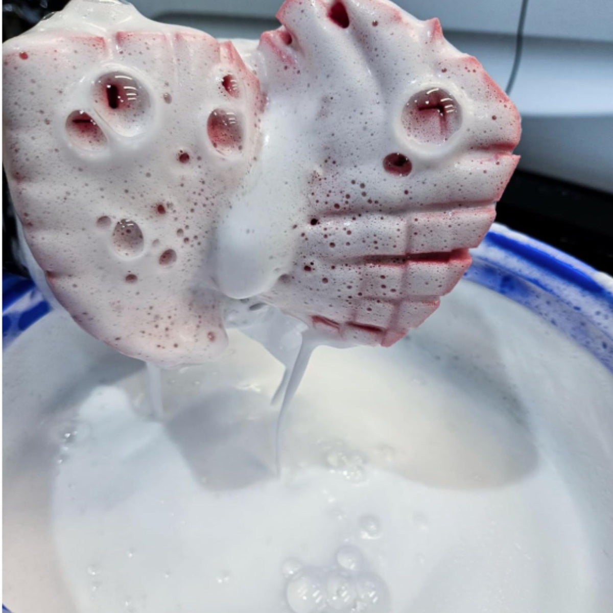 diy detail sponge soaking in soapy bucket holding more suds for longer lubrication