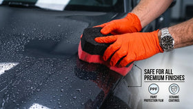 diy detail product being sprayed and wiped on car panel for safe cleaning
