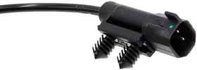 Dorman ABS sensor next to ruler for scale showing compact design and straightforward installation