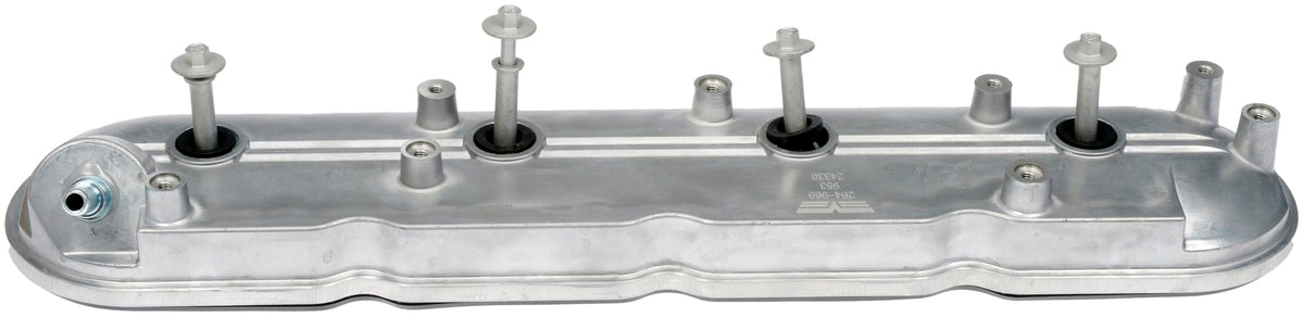 Dorman valve cover next to ruler for size comparison to confirm proper fitment