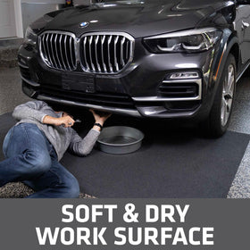 Drymate mat positioned under car catching oil and protecting concrete