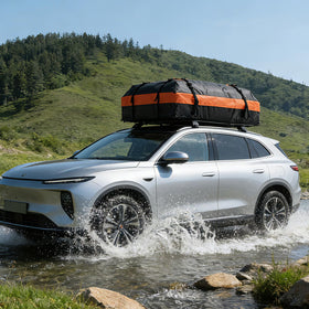 DUMOS roof bag on car at campground showing extra storage for outdoor gear