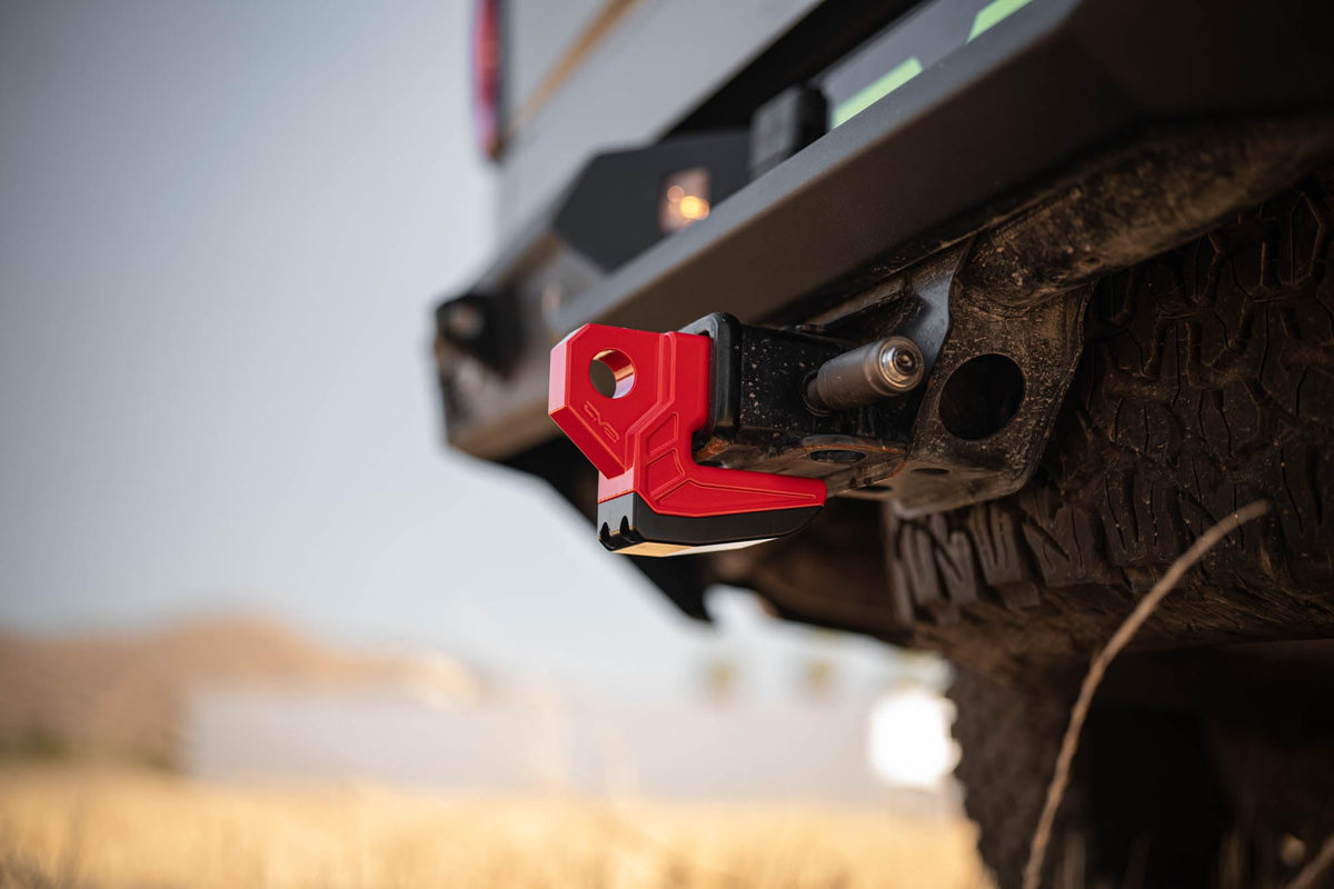 DV8 Offroad skid plate installed on a truck demonstrating hitch protection benefit