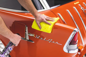 Detailing kit with towel, spray bottle, and polish showing The Rag Company towel speeding final buff