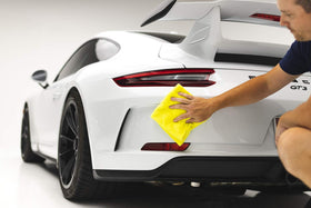 Towel next to ruler showing 16x16 size and scale, The Rag Company benefit: precise fit for detailing