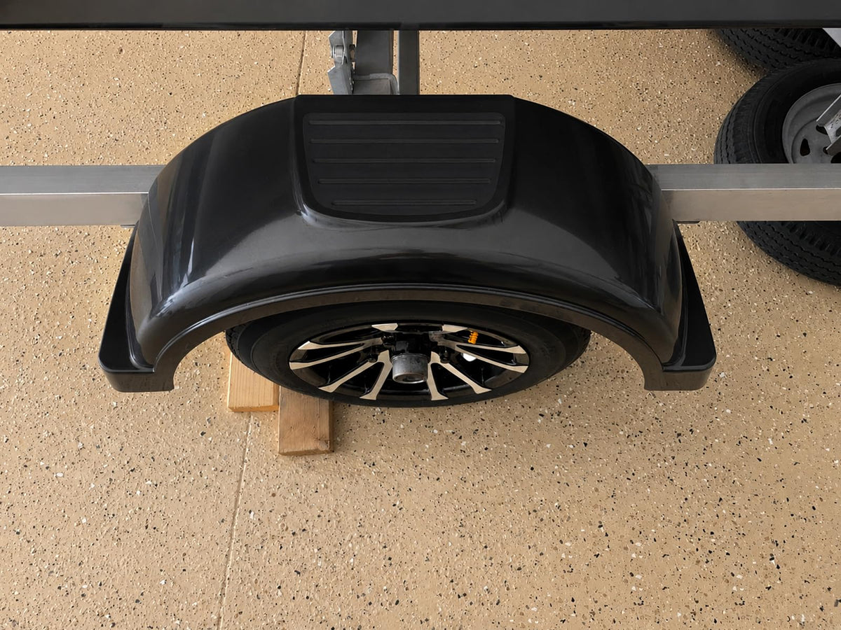 ECOTRIC lifestyle scene of user stepping on fender to load trailer for convenience