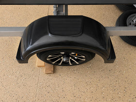 ECOTRIC lifestyle scene of user stepping on fender to load trailer for convenience