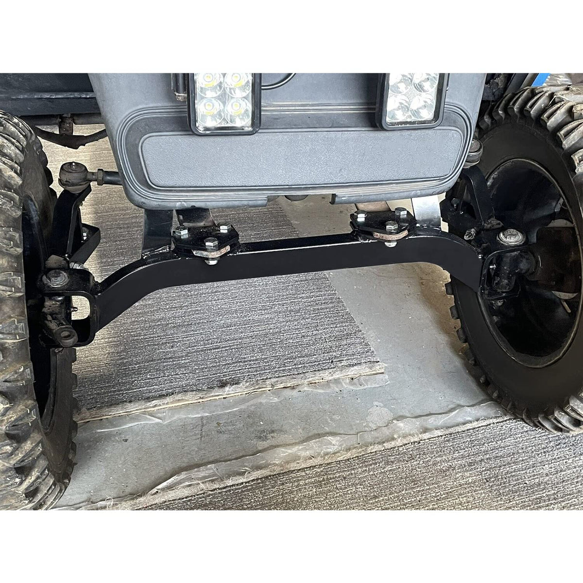 ECOTRIC lift kit installed on EZGO front, improved ground clearance visible