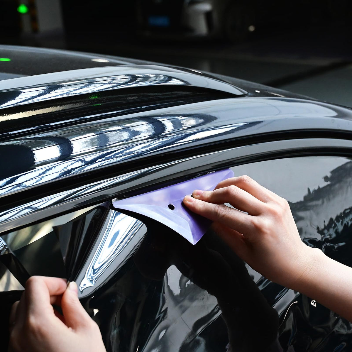 EHDIS squeegee in use on a car window removing air bubbles for a smoother tint installation