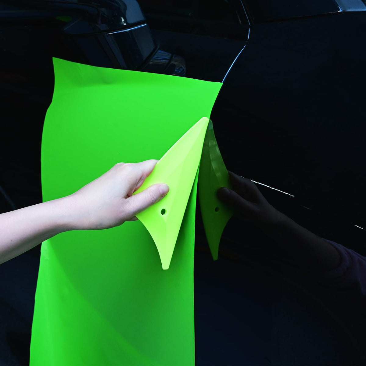 EHDIS squeegees next to a ruler showing scale and compact design for handheld control