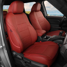 EKR front seats full set fitted on Tacoma showing clean burgundy upgrade and protection