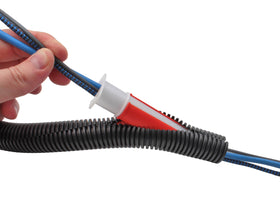 Electriduct tool straightening and feeding split loom to protect cable jackets
