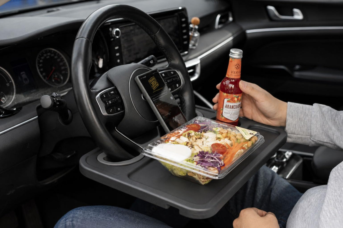 ENRICH UP lifestyle shot driver using tray to work comfortably while parked