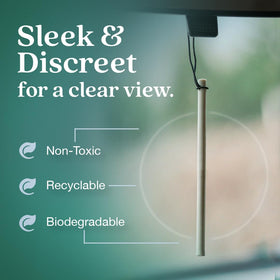 Car cabin on a road trip with Auto Stix visible, conveying Enviroscent long-lasting freshness benefit