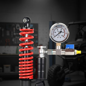ENYSAON kit attached to ATV shock demonstrating on-shock pressure verification