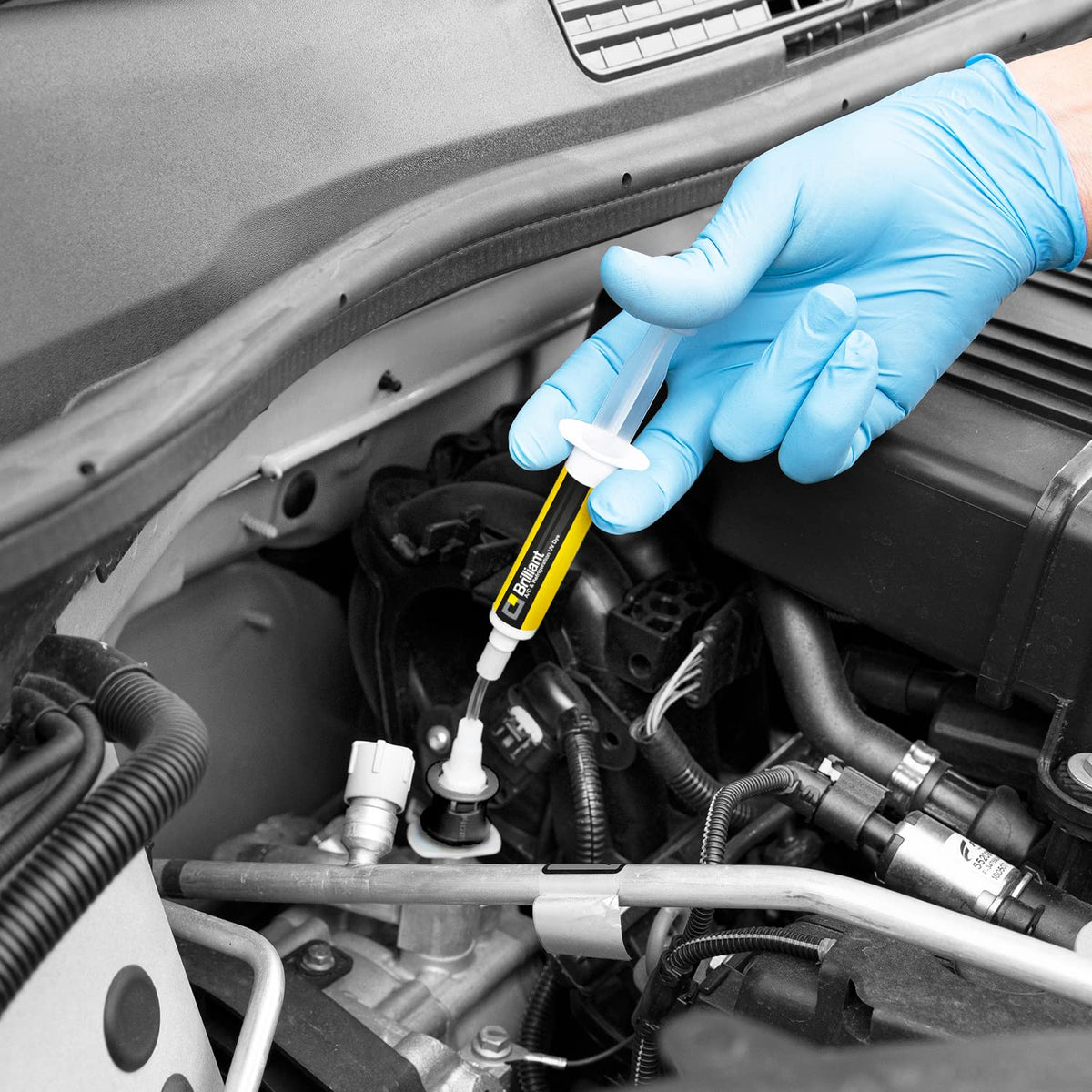 Technician using ERRECOM Brilliant adapter to inject dye into vehicle A/C port for practical use