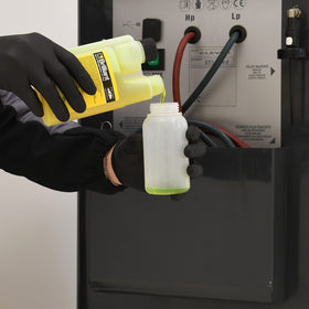Errecom Brilliant fluorescent dye glowing on A/C tubing under UV light, clear leak detection