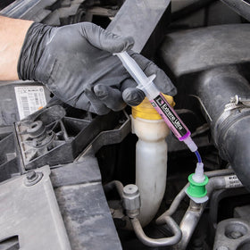 Technician applying Errecom Extreme Ultra to a vehicle A/C system during service