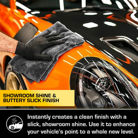 Ethos Handcrafted Car Care microfiber towel applying spray to create streak-free shine