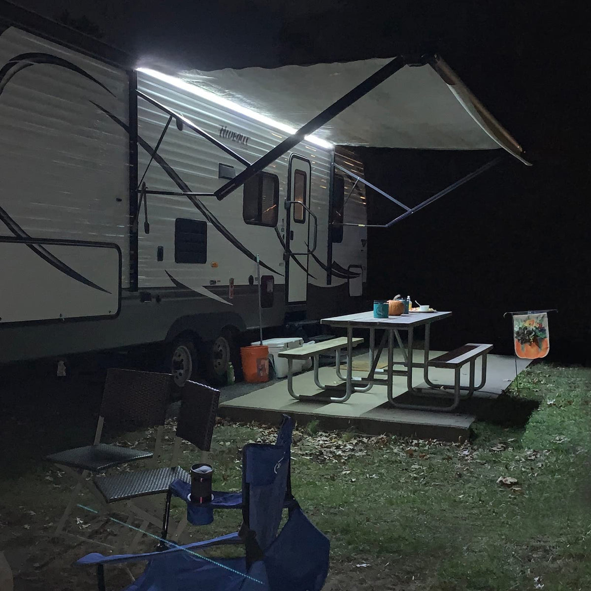 EXCELFU lifestyle camper evening scene showing lit awning for cozy gatherings benefit ambiance