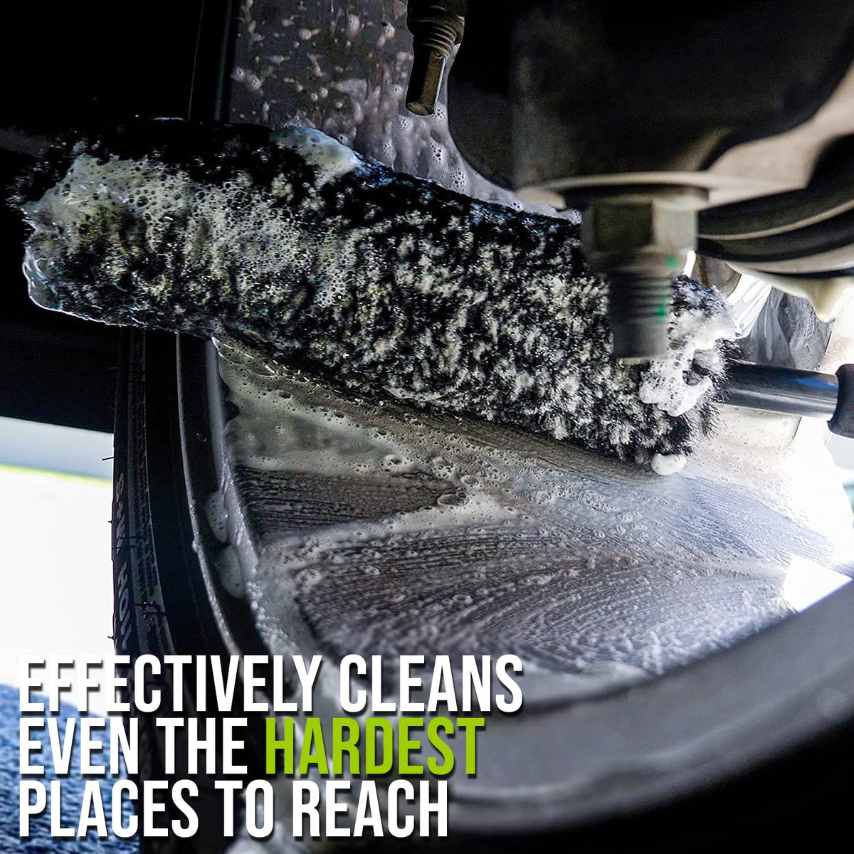 ExoForma brush bent to an angle in use reaching behind wheel barrel for deep cleaning