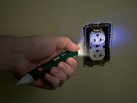 Extech MD10 held near solenoid valve showing hands-free detection benefit