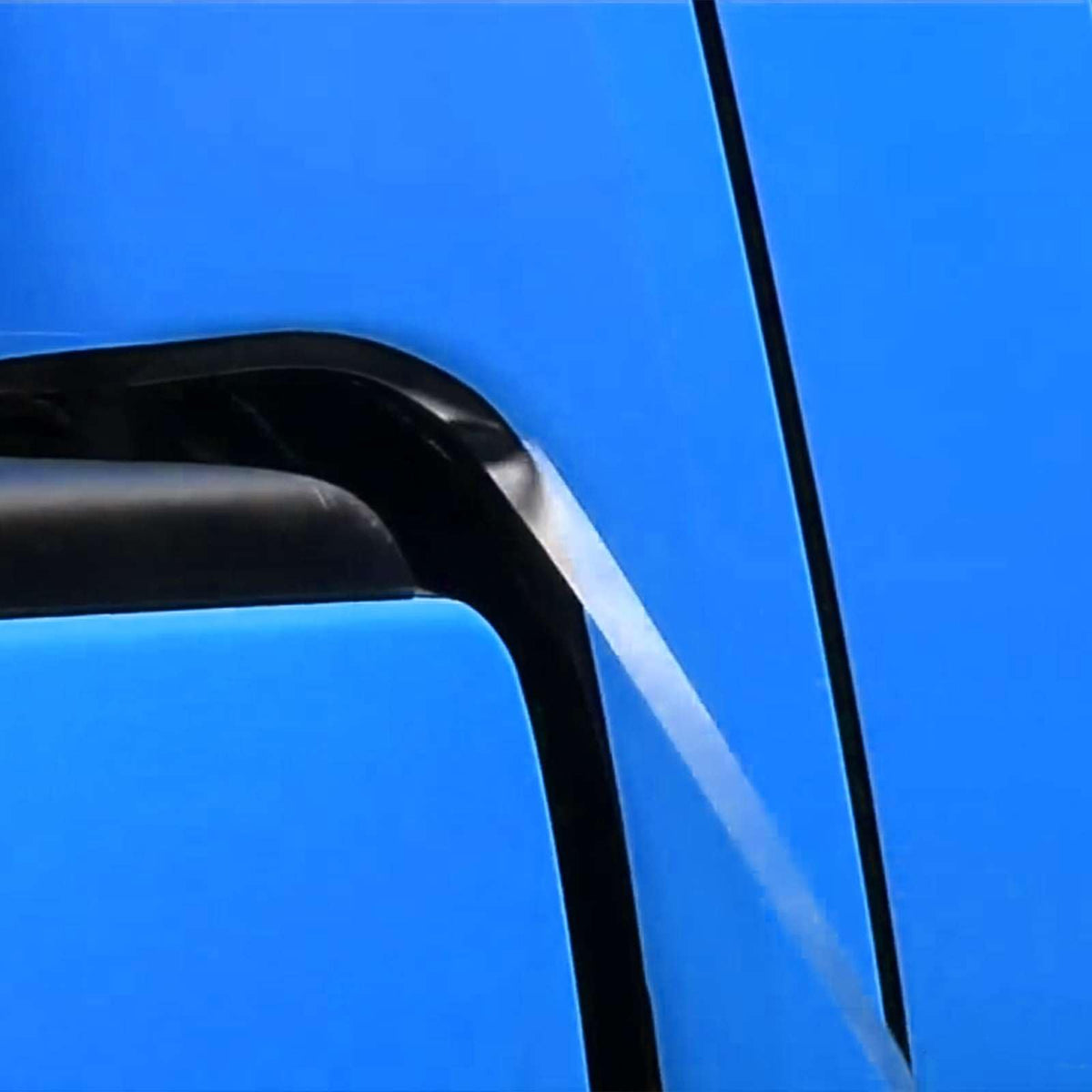 Applying EZAUTO WRAP 8914ES along windshield perforated vinyl to prevent wiper damage