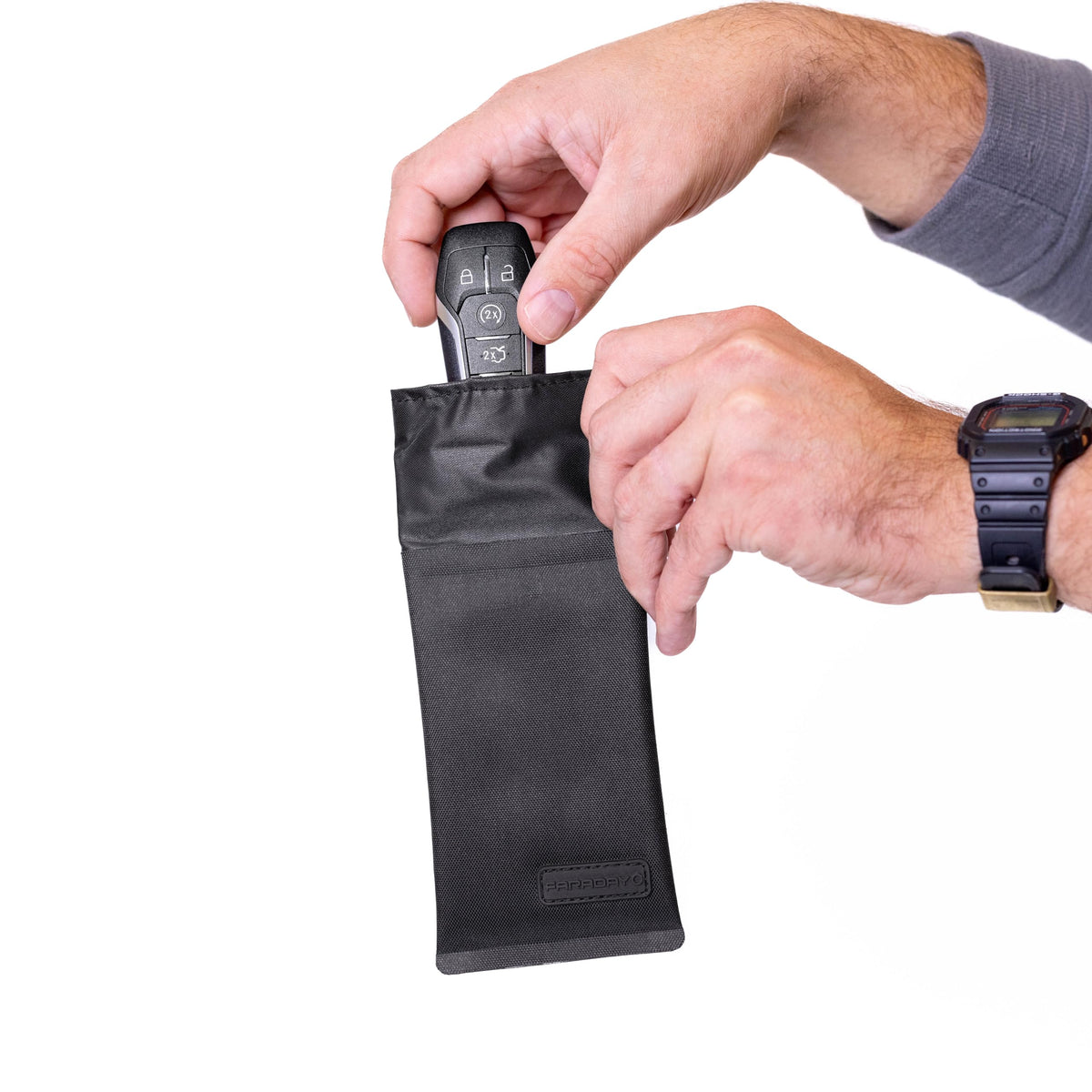 Faraday Defense next to a smartphone to show scale and compact travel-ready protection