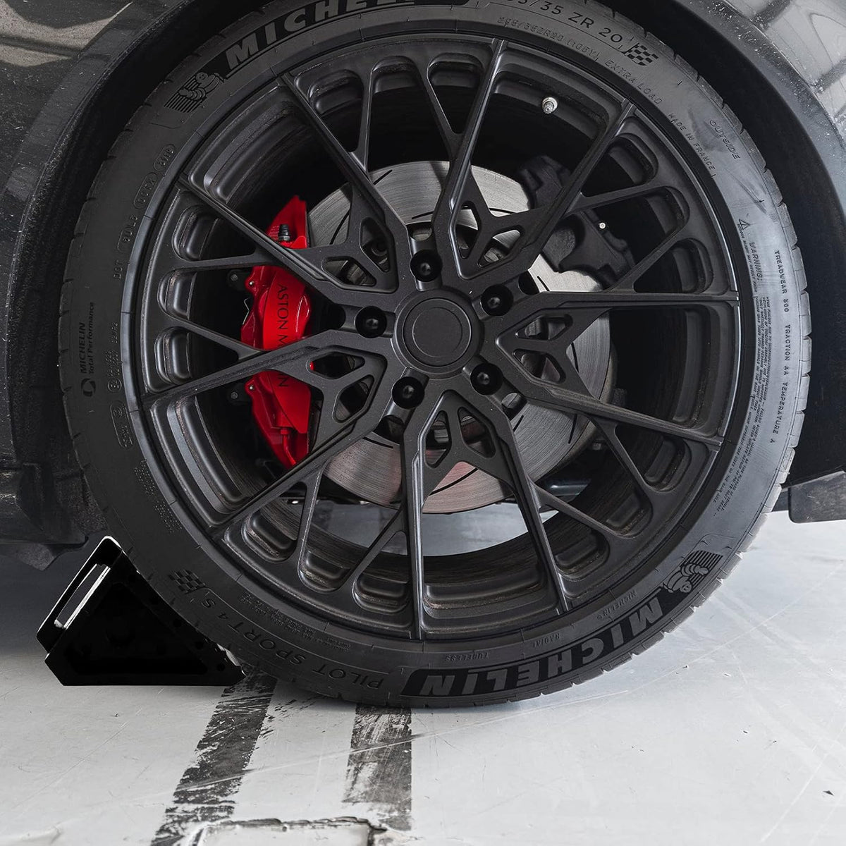 Fasmov chock placed by an RV wheel demonstrating secure stabilization benefit