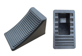 Fasmov chock placed under car wheel demonstrating secure parking