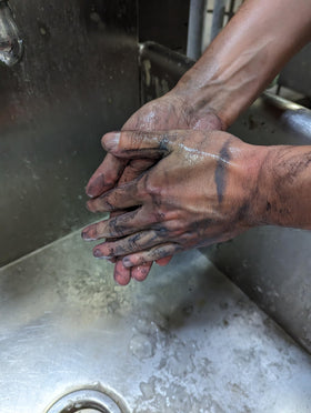 Mechanic using Fast Orange Xtreme at a shop sink removing grease for faster hand cleanup