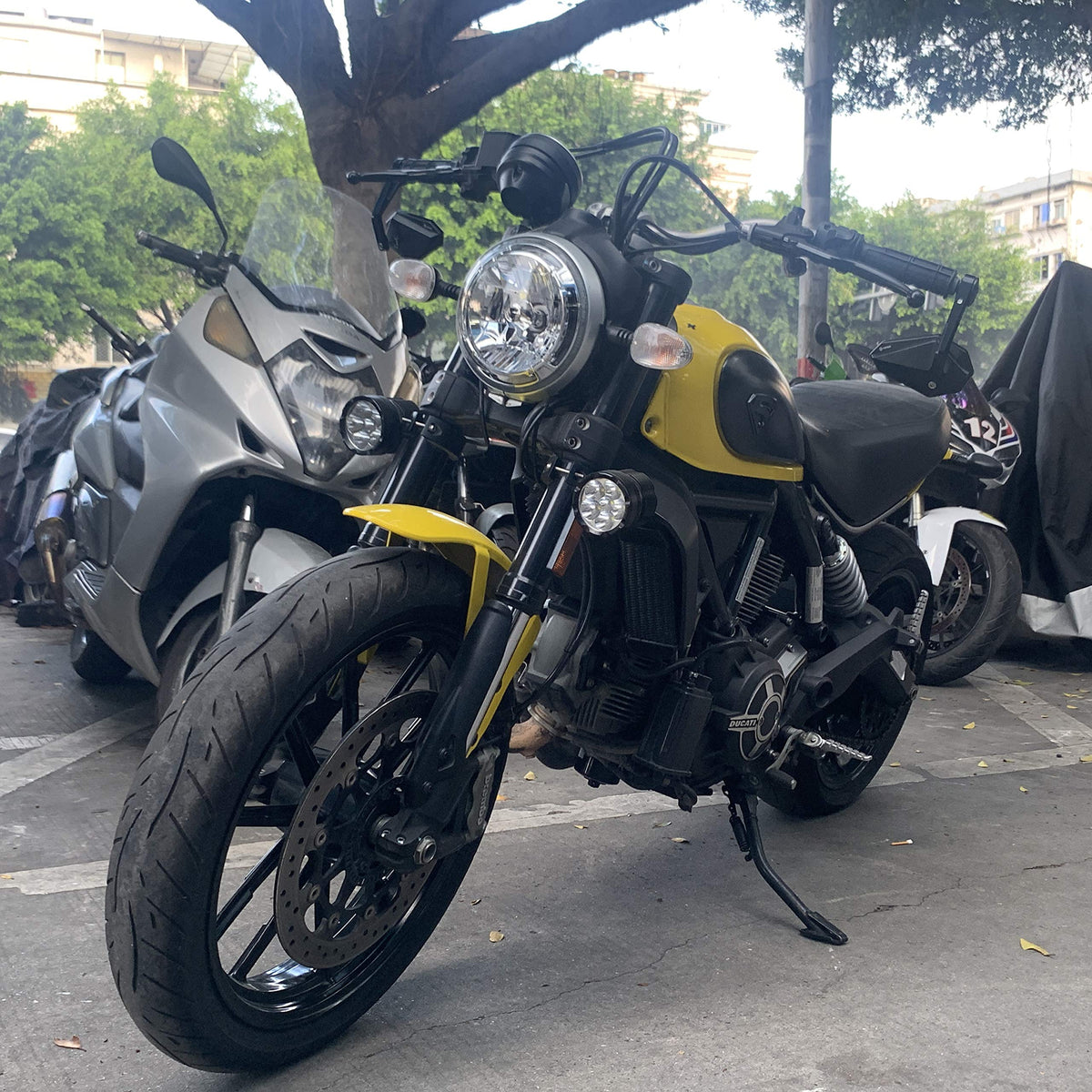 FENRIR mirrors on motorcycle in urban setting conveying stylish, practical use
