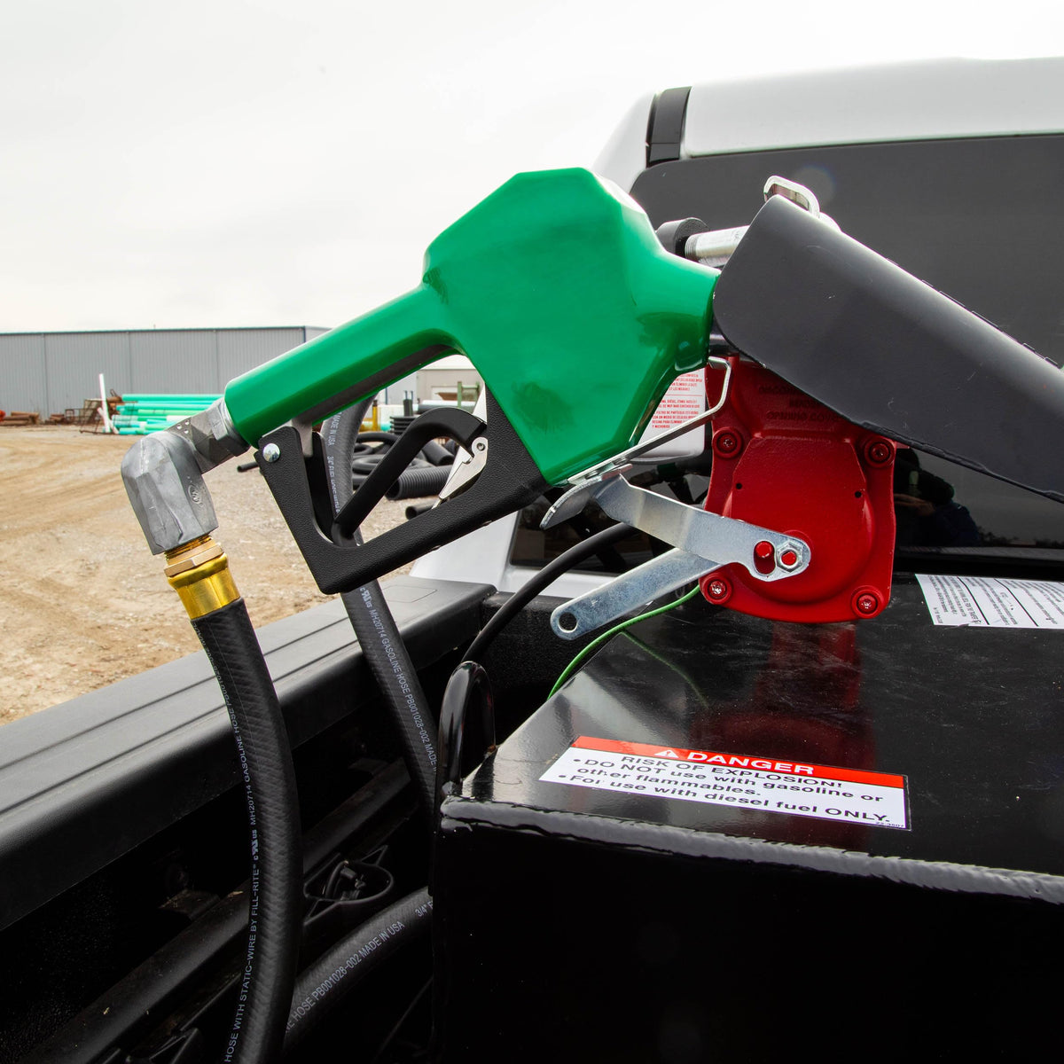 Fill-Rite nozzle in use refueling a pickup, demonstrating quick safe automatic shut-off