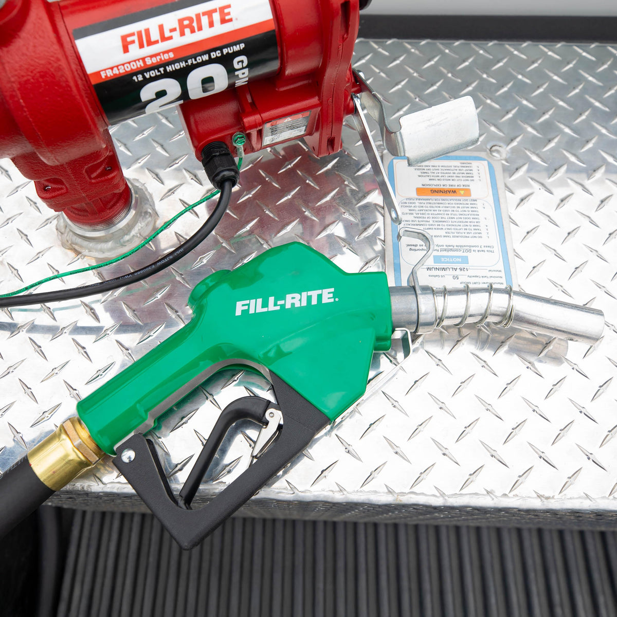 Fill-Rite nozzle beside ruler showing scale and 1" inlet compatibility