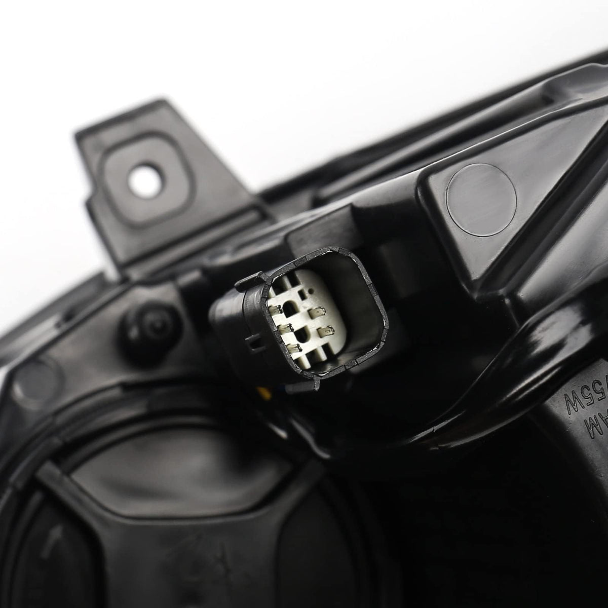 FIONE headlight held in hand for scale showing compact design and straightforward handling