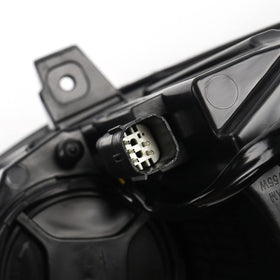 FIONE headlight held in hand for scale showing compact design and straightforward handling