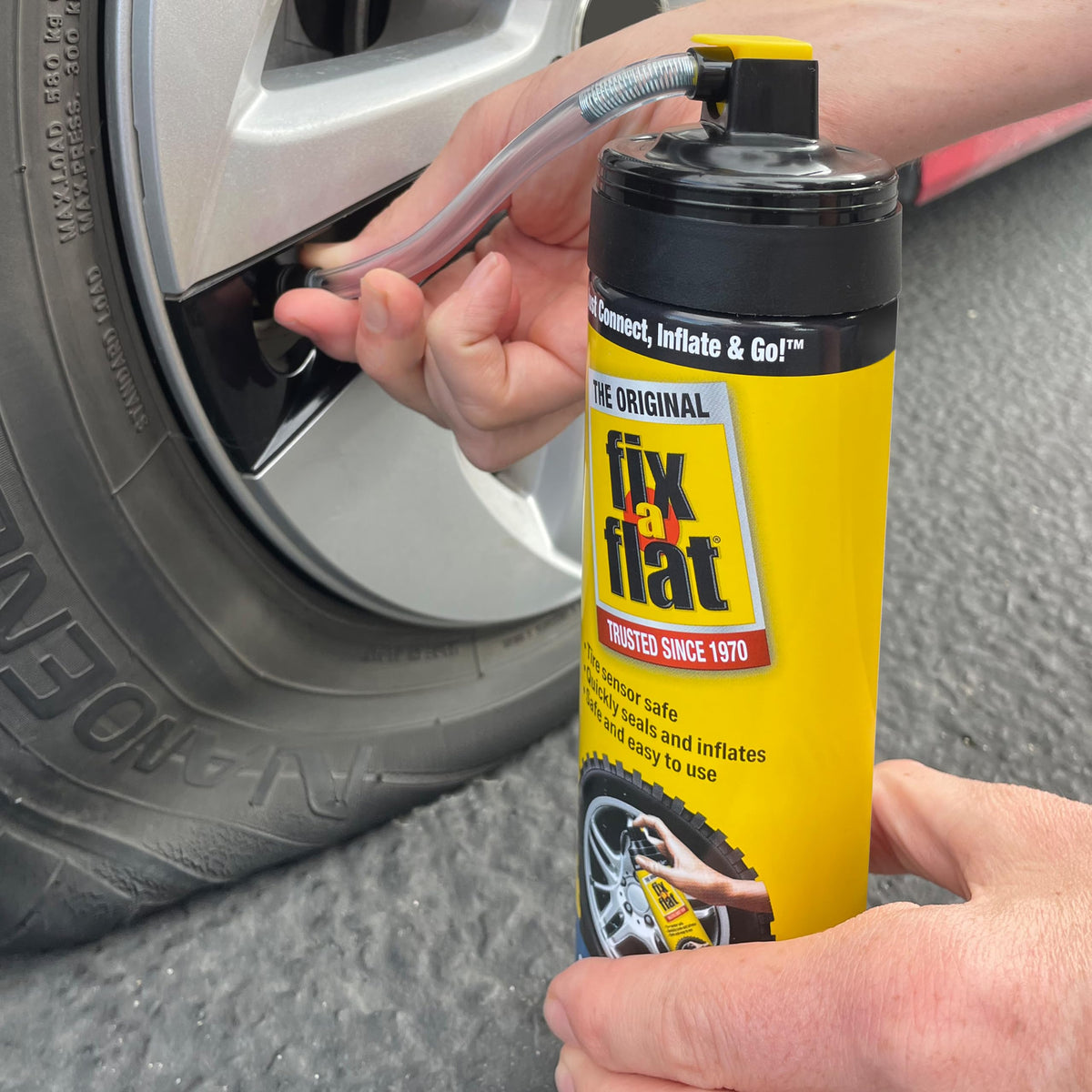 Fix-A-Flat stored in car trunk demonstrating convenient roadside storage