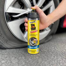 Fix-A-Flat sealing a tread puncture on tire showing fast temporary repair