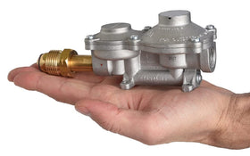 Flame King regulator installed under RV cabinet showing neat gas line routing