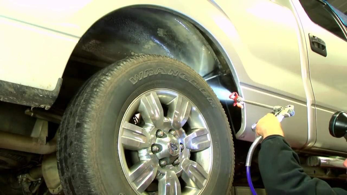 Fluid Film black being brushed onto chassis showing corrosion prevention benefit