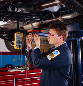 Fluke 88V being used under a car hood to troubleshoot hybrid vehicle circuits
