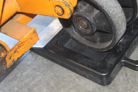 Foghorn chock placed against pallet jack wheel inside trailer reducing movement