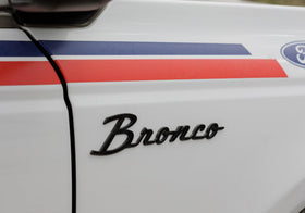 Ford bronco badge installed on vehicle fender in outdoor setting benefit: enhances rugged appearance
