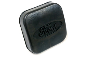Ford trailer hitch cover beside ruler for accurate size comparison