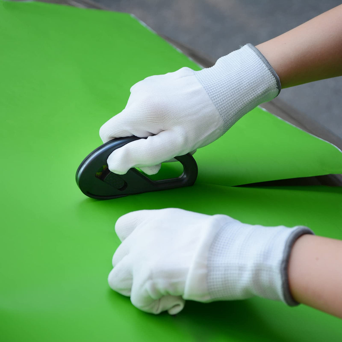 FOSHIO tools being used on a car during wrap install showing professional workflow